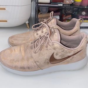 Rose gold metallic Nike sneakers